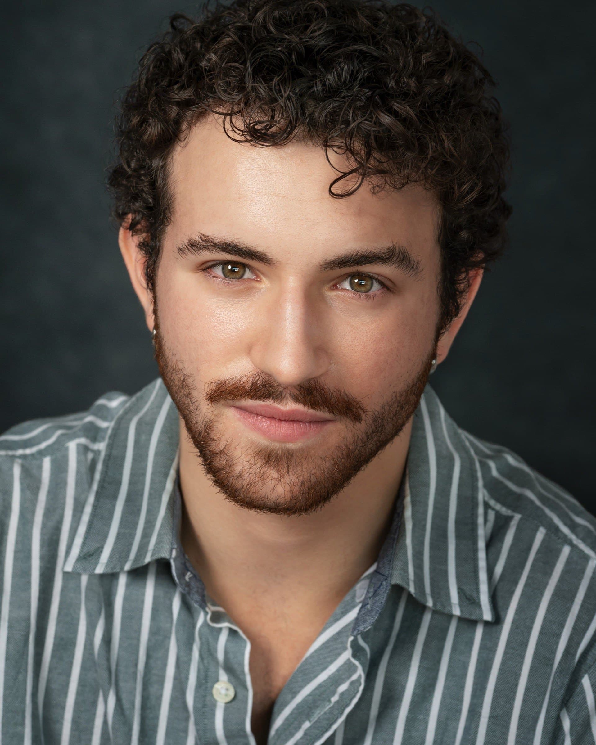 AJ DeAugustine, headshot in a striped shirt